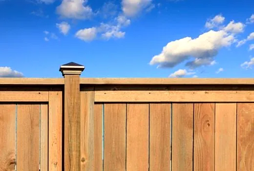 New board-on-board cedar privacy fence with a cap rail