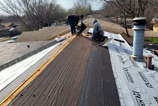 Roofing crew replacing a residential roof